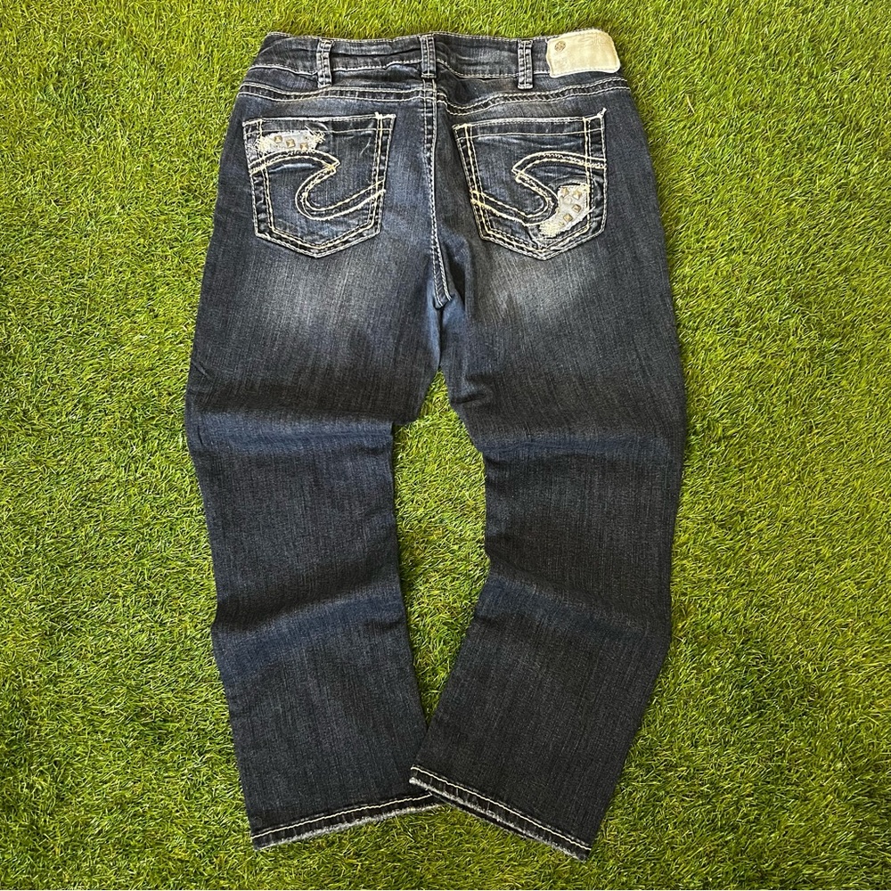 Dark washed thick stitched silver jeans with studded details